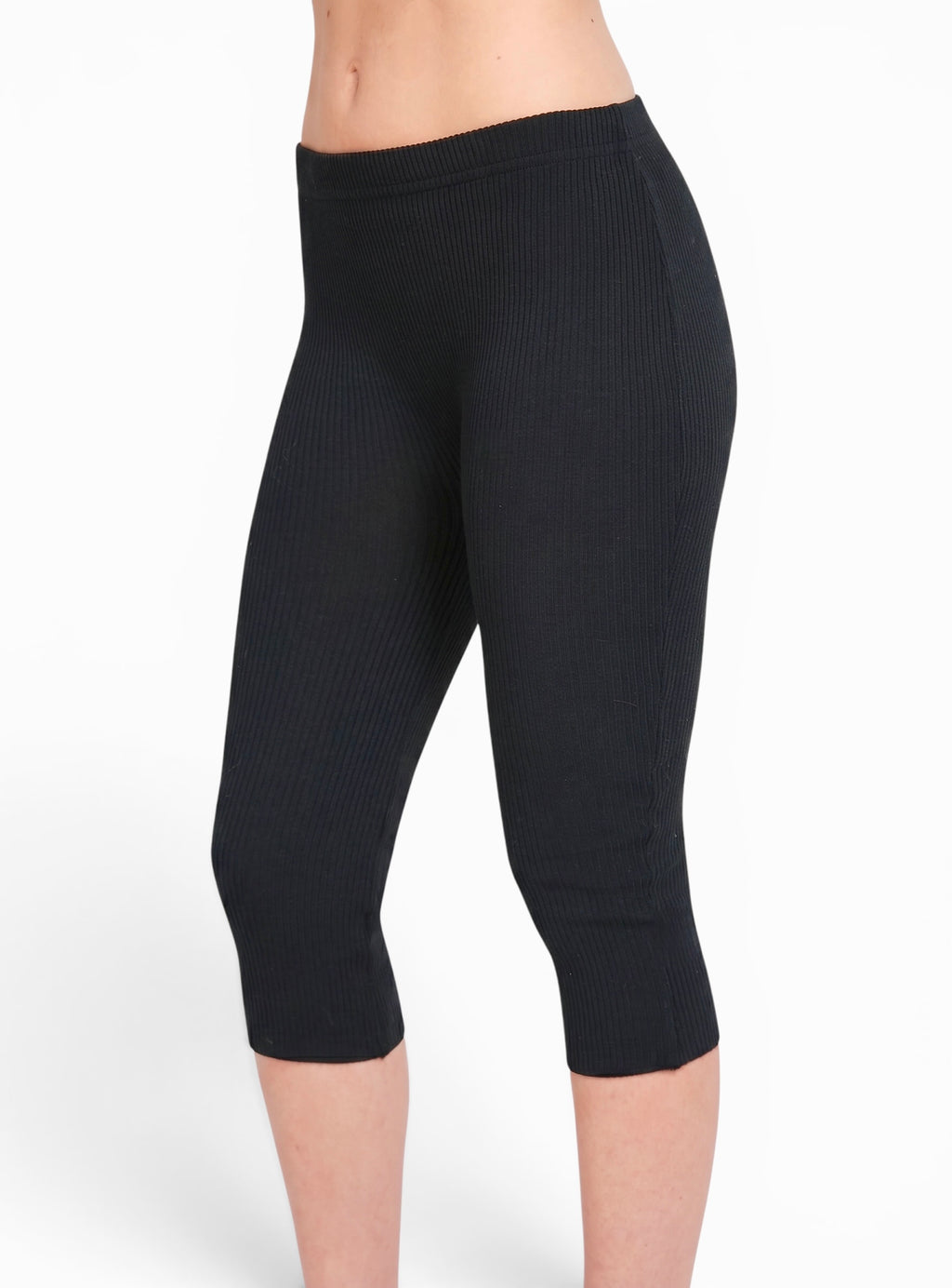 Side view of black rib knit Capri pants by TKHLA