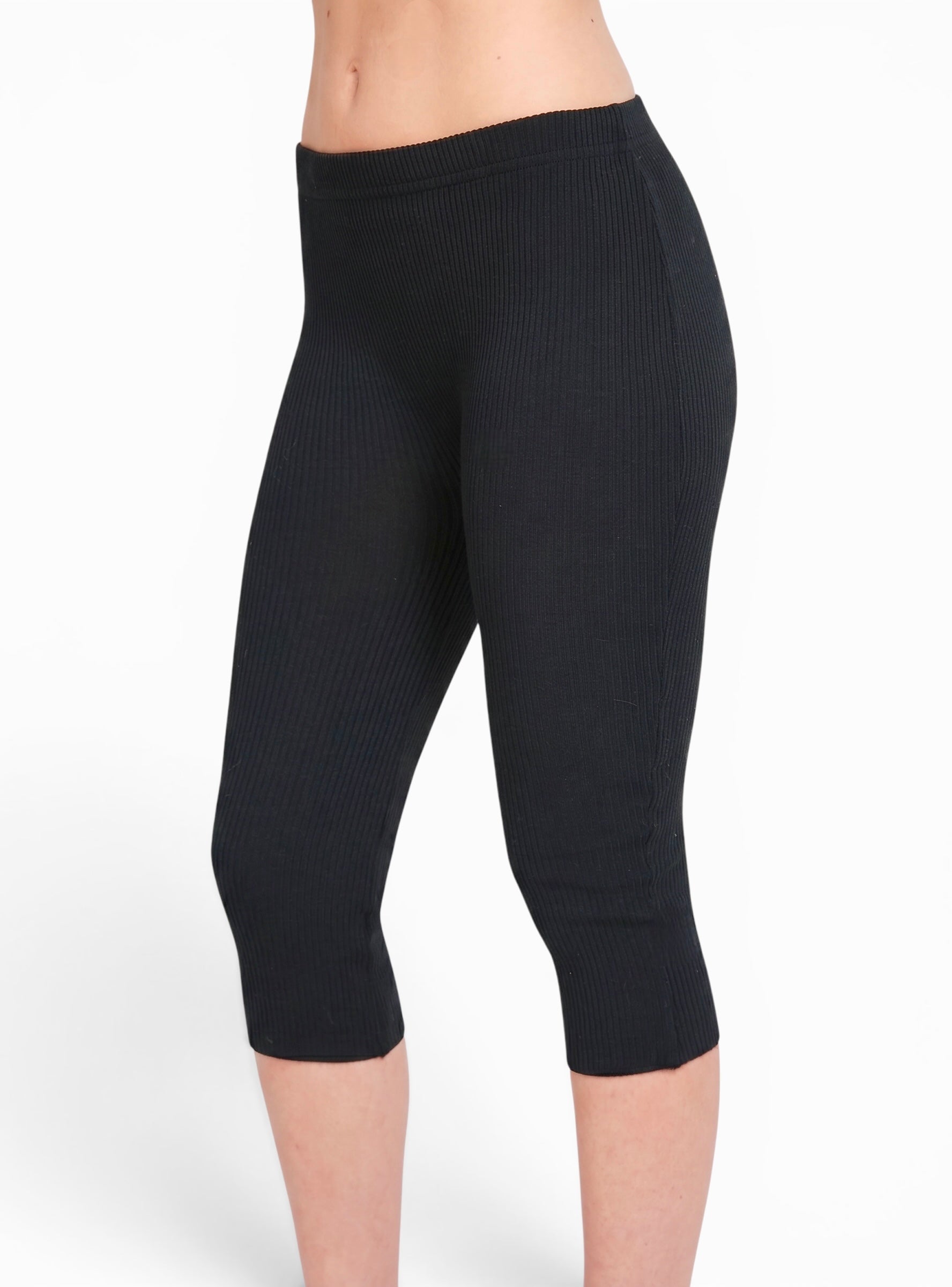 Side view of black rib knit Capri pants by TKHLA