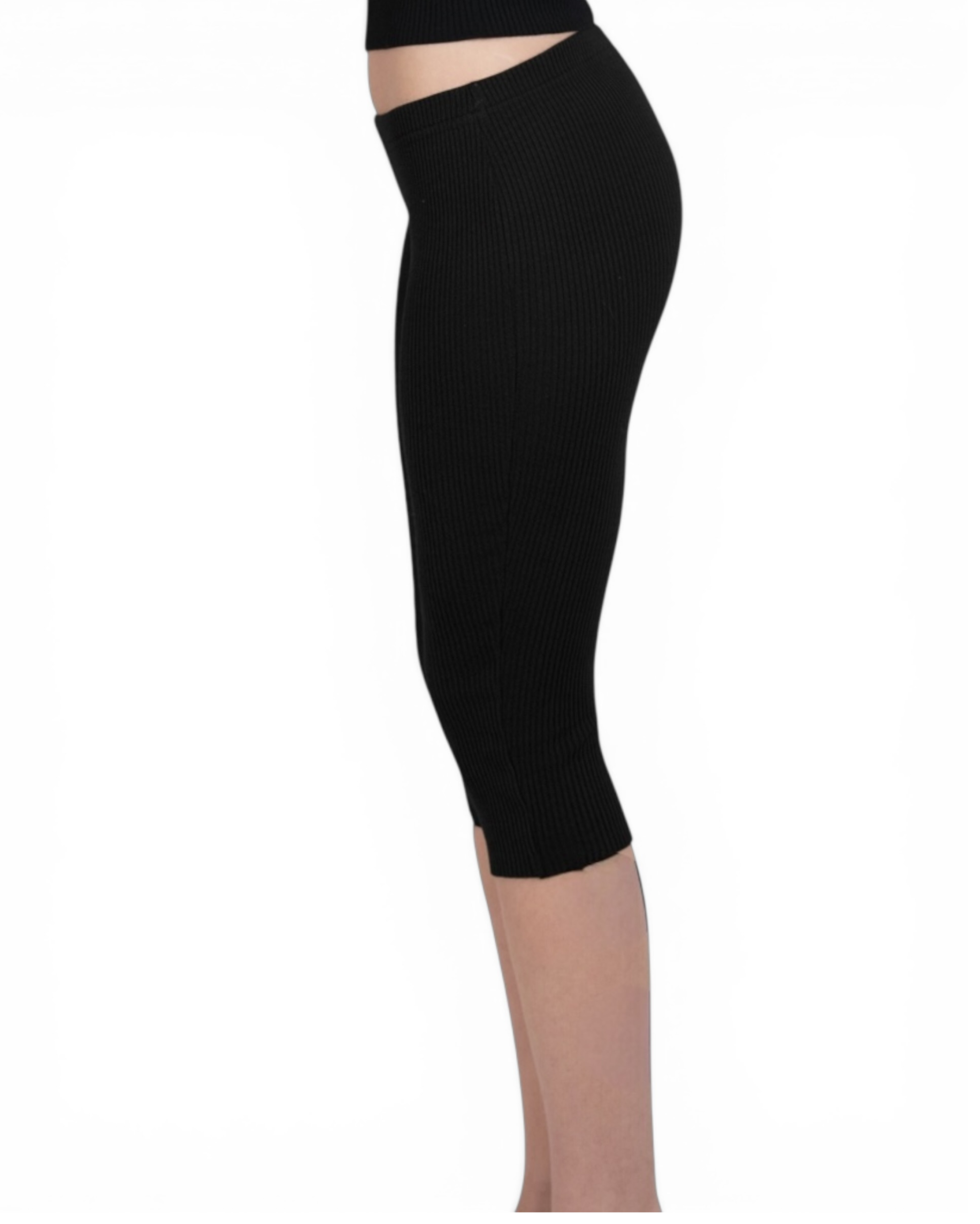 Black capri leggings worn by a person on a white background