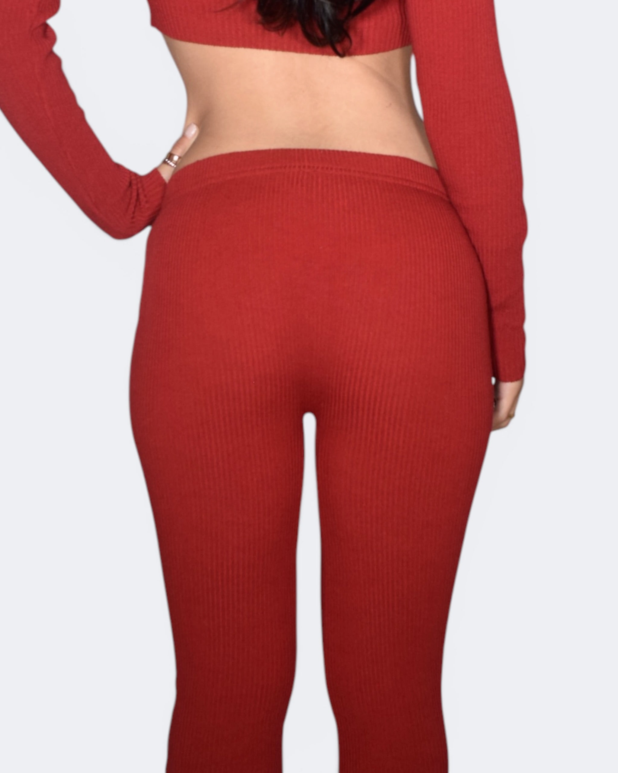 Red ribbed knit outfit on a plain background