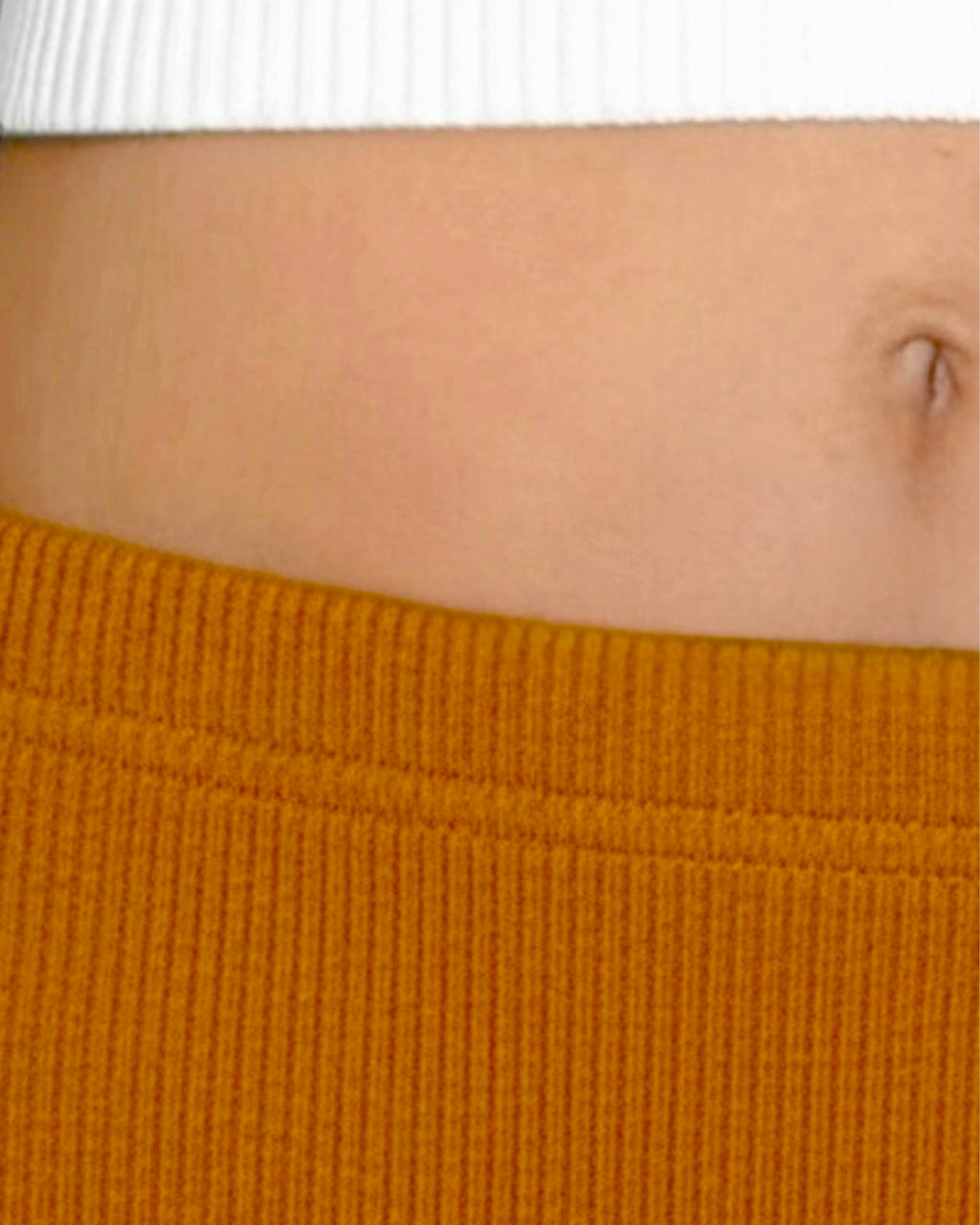 Close up of mustard yellow waistline and midriff. By The Knit House LA