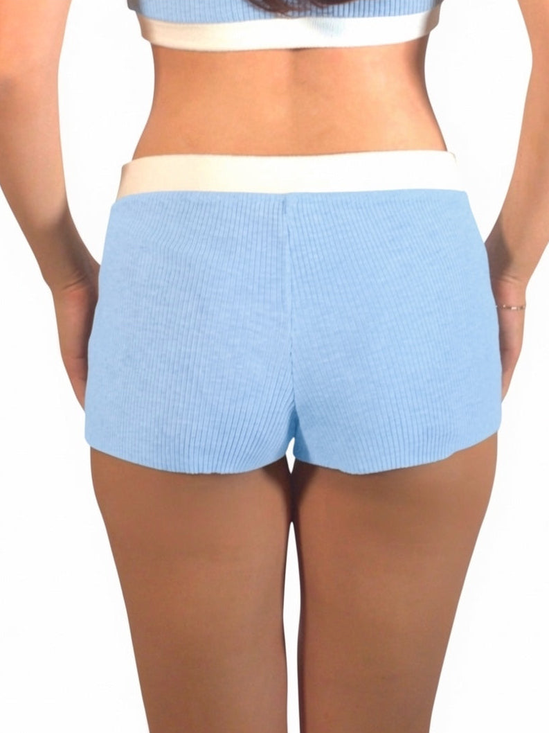 Light blue shorts worn by a person on a white background