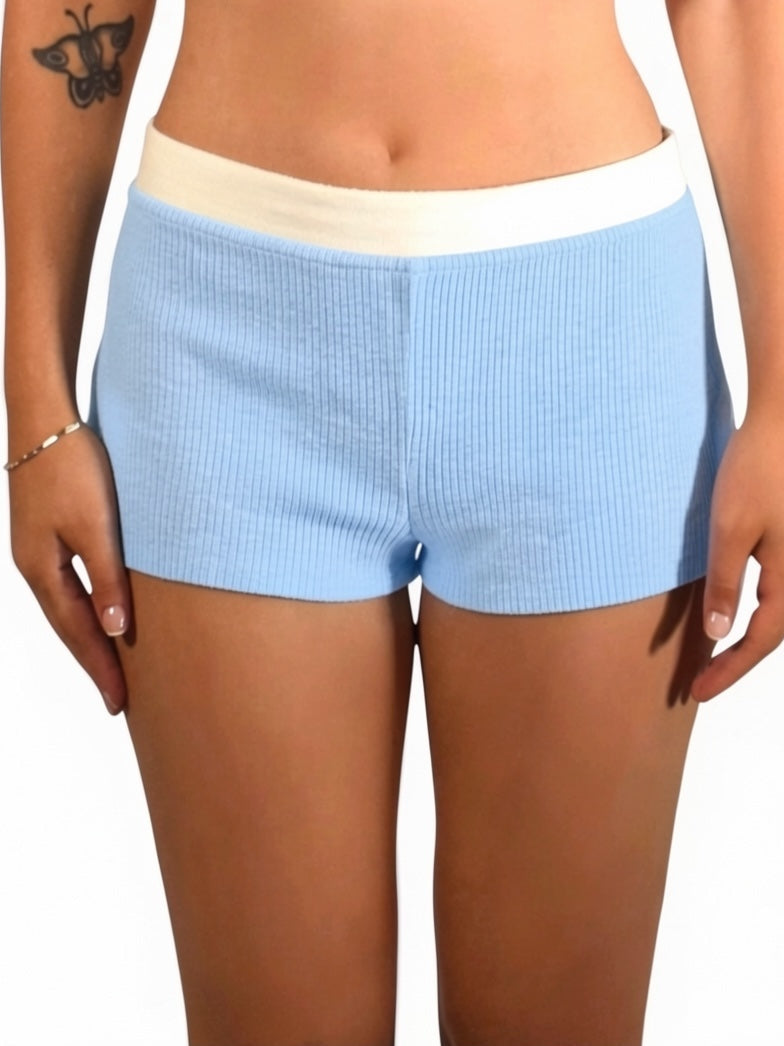 Light blue shorts worn by a person on a white background