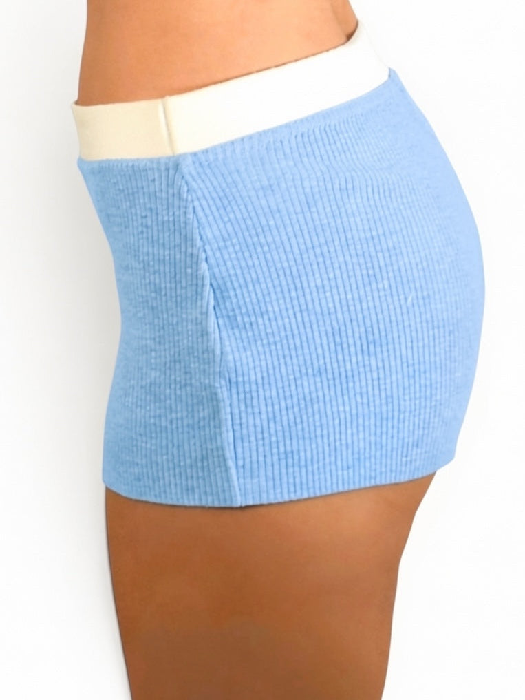 Light blue ribbed shorts worn by a person on a white background