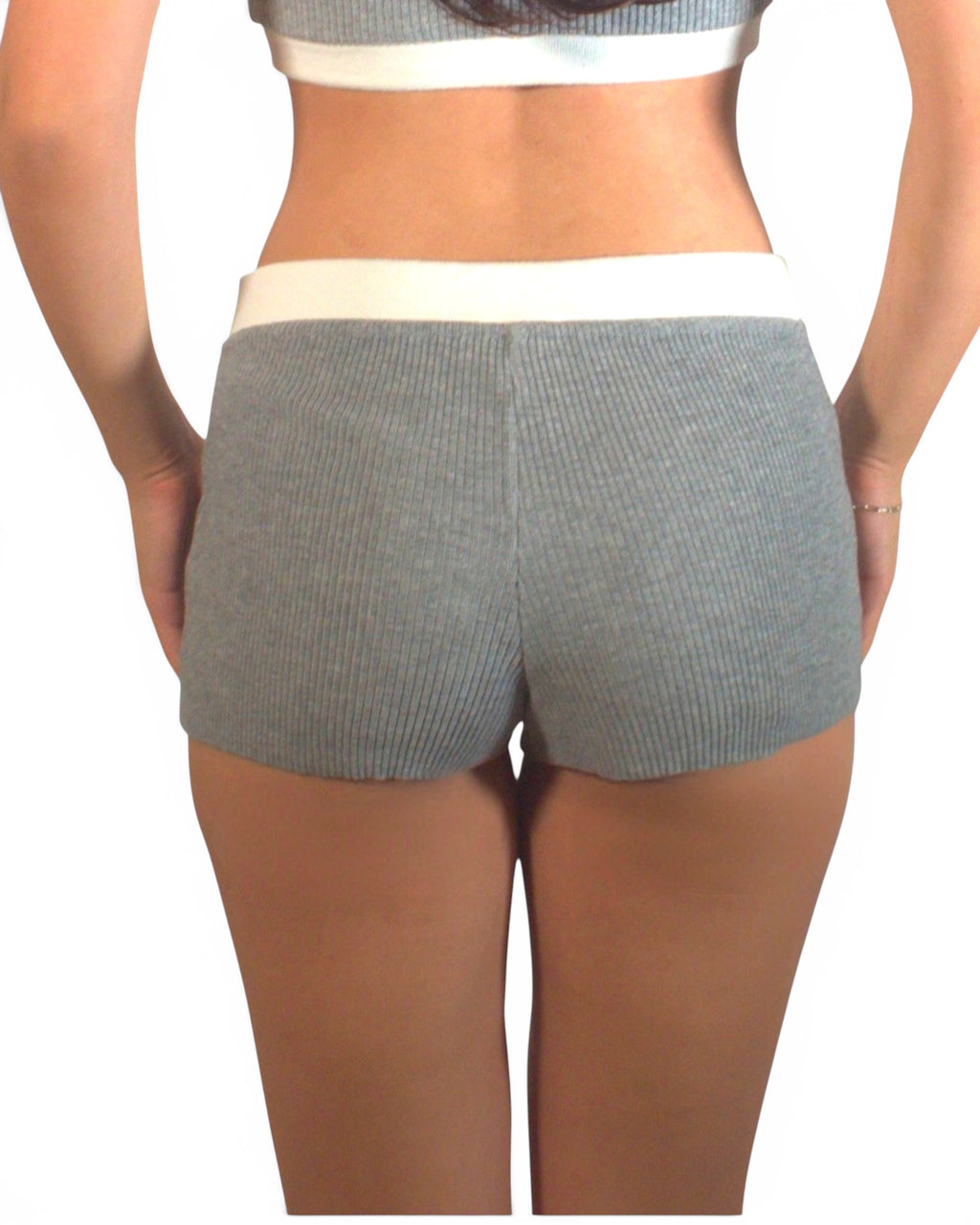 Person wearing gray shorts on a white background