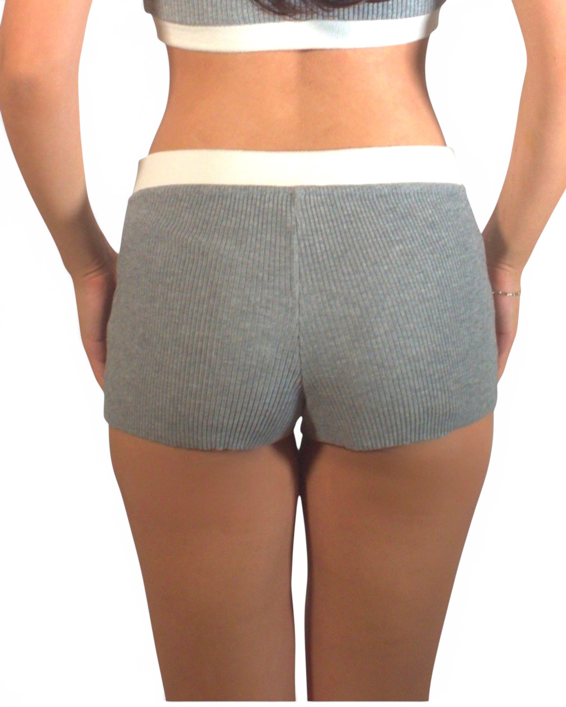 Person wearing gray shorts on a white background