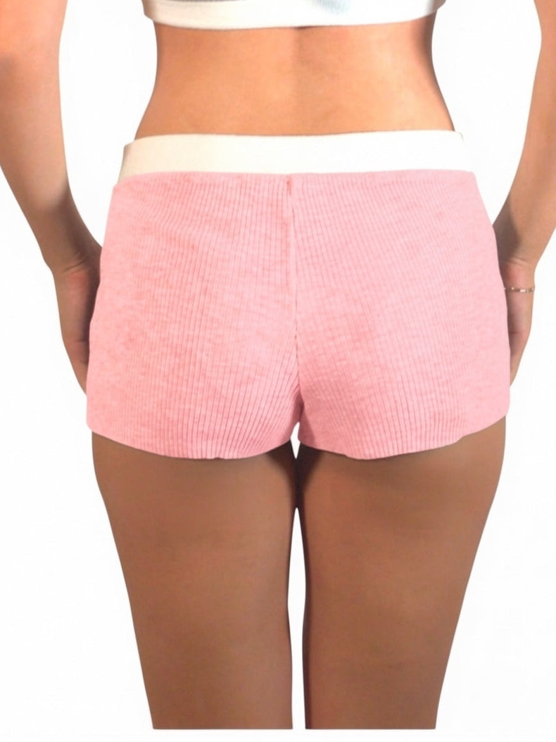 Person wearing pink shorts on a white background