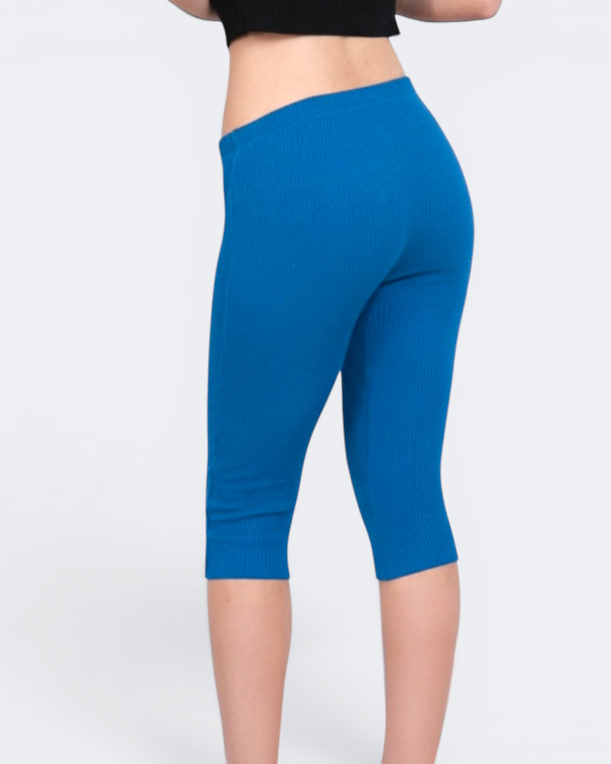 Blue capri leggings worn by a person on a white background