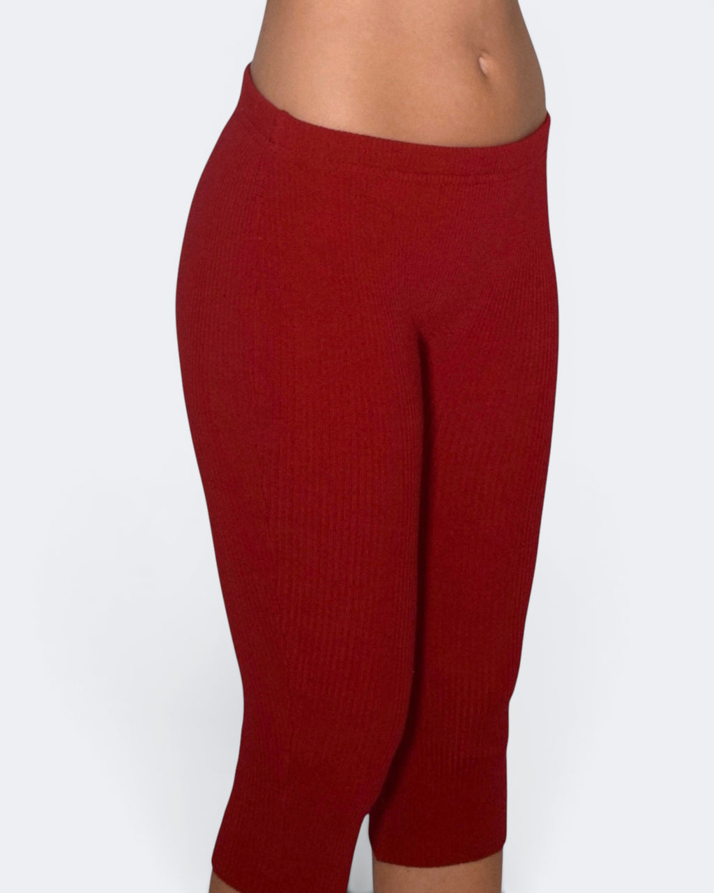 Red leggings worn by a person on a white background