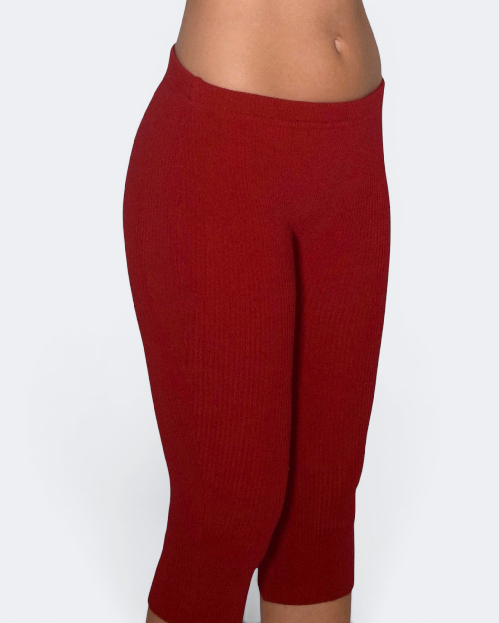 Red leggings worn by a person on a white background