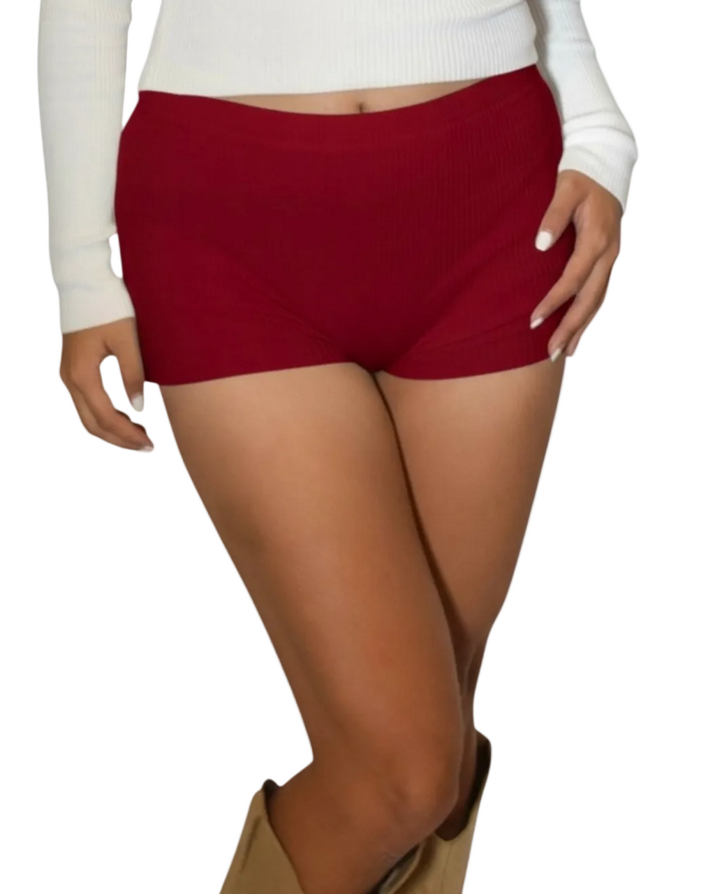 Person wearing red shorts and brown knee-high boots on a white background