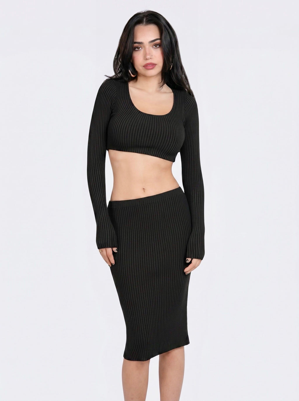 Woman wearing matching black knit crop top and pencil skirt by TKHLA 