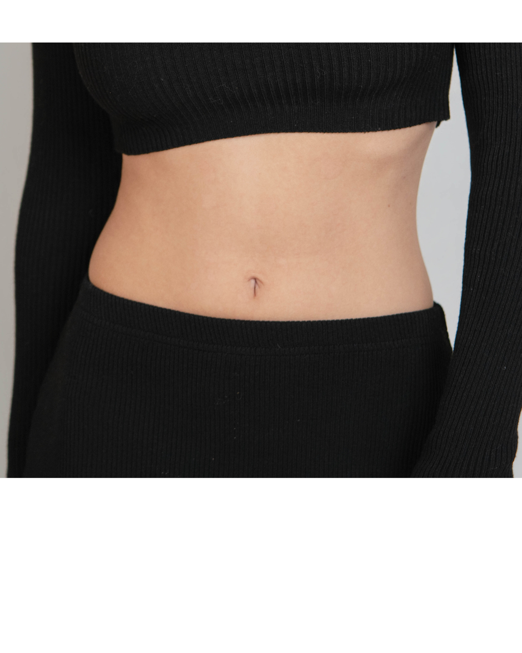 Close up of black skirt waistband  with a plain background