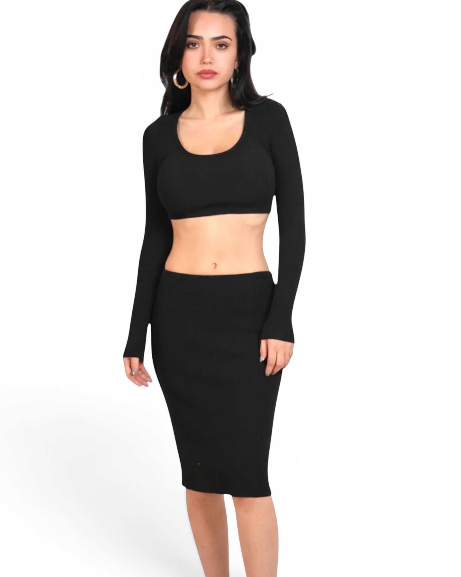 Woman wearing a black long-sleeve top and black pencil skirt on a white background