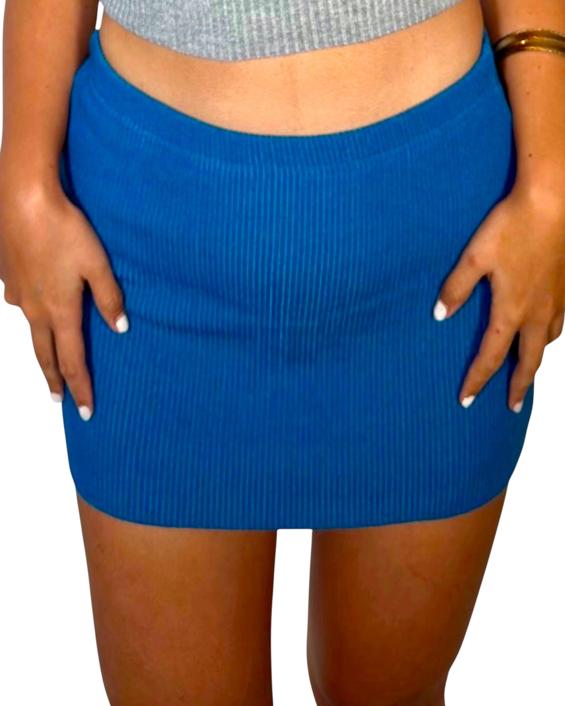 Blue skirt worn by a person on a white background