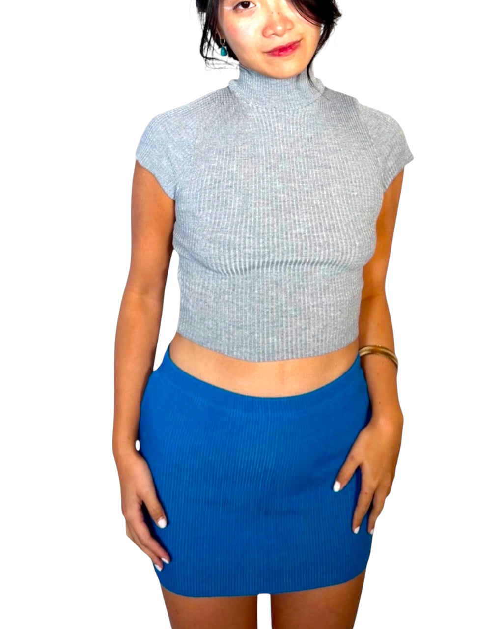Woman wearing grey top with cobalt knit mini skirt by The Knit House LA