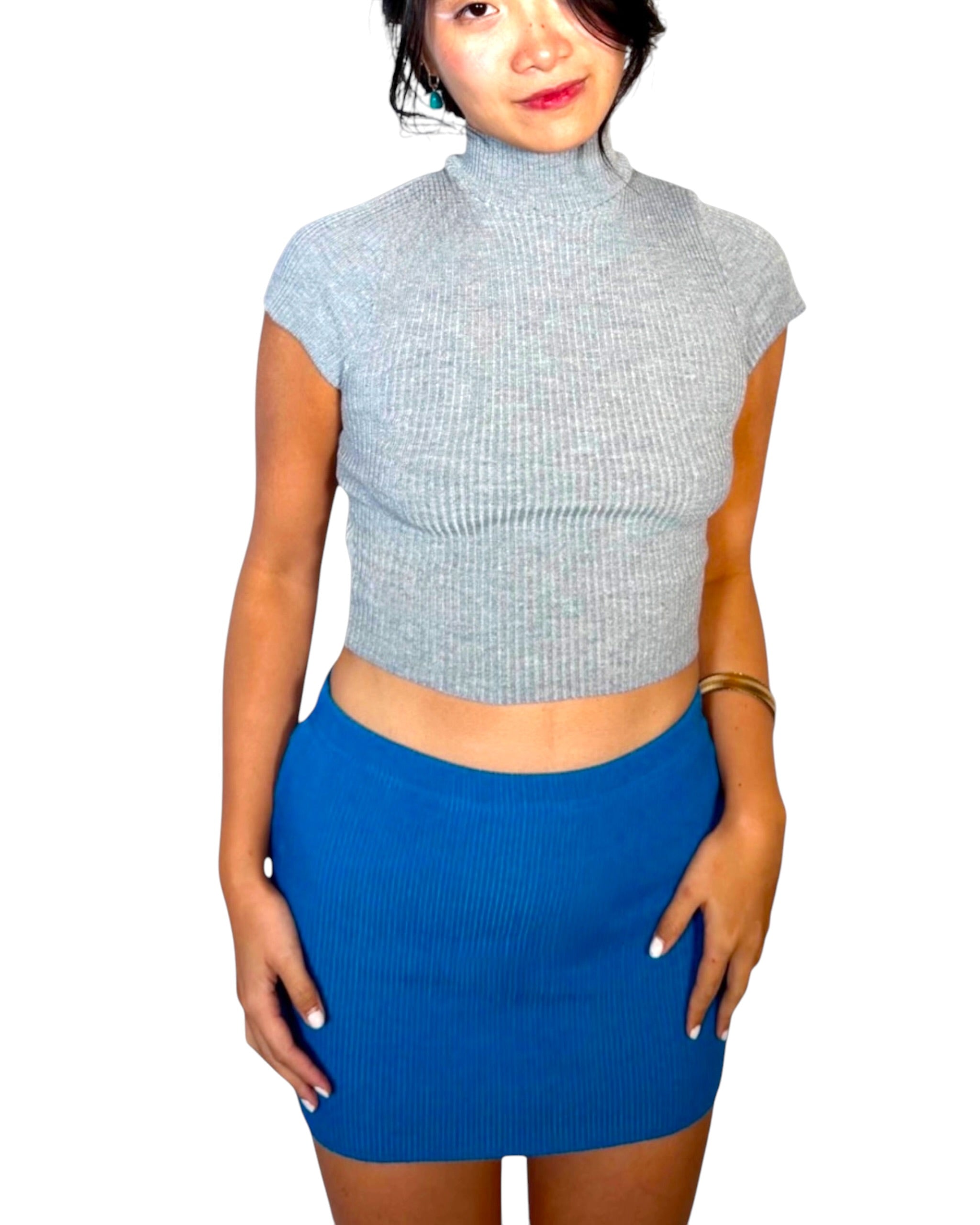 Woman wearing grey top with cobalt knit mini skirt by The Knit House LA