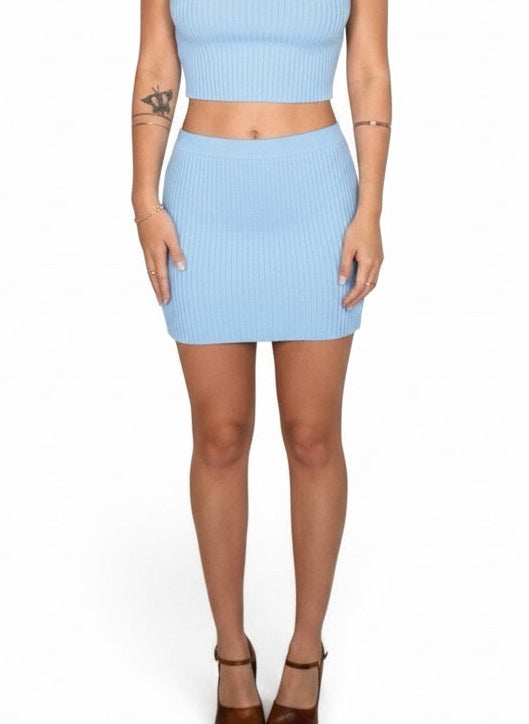 Woman wearing a light blue outfit on a white background