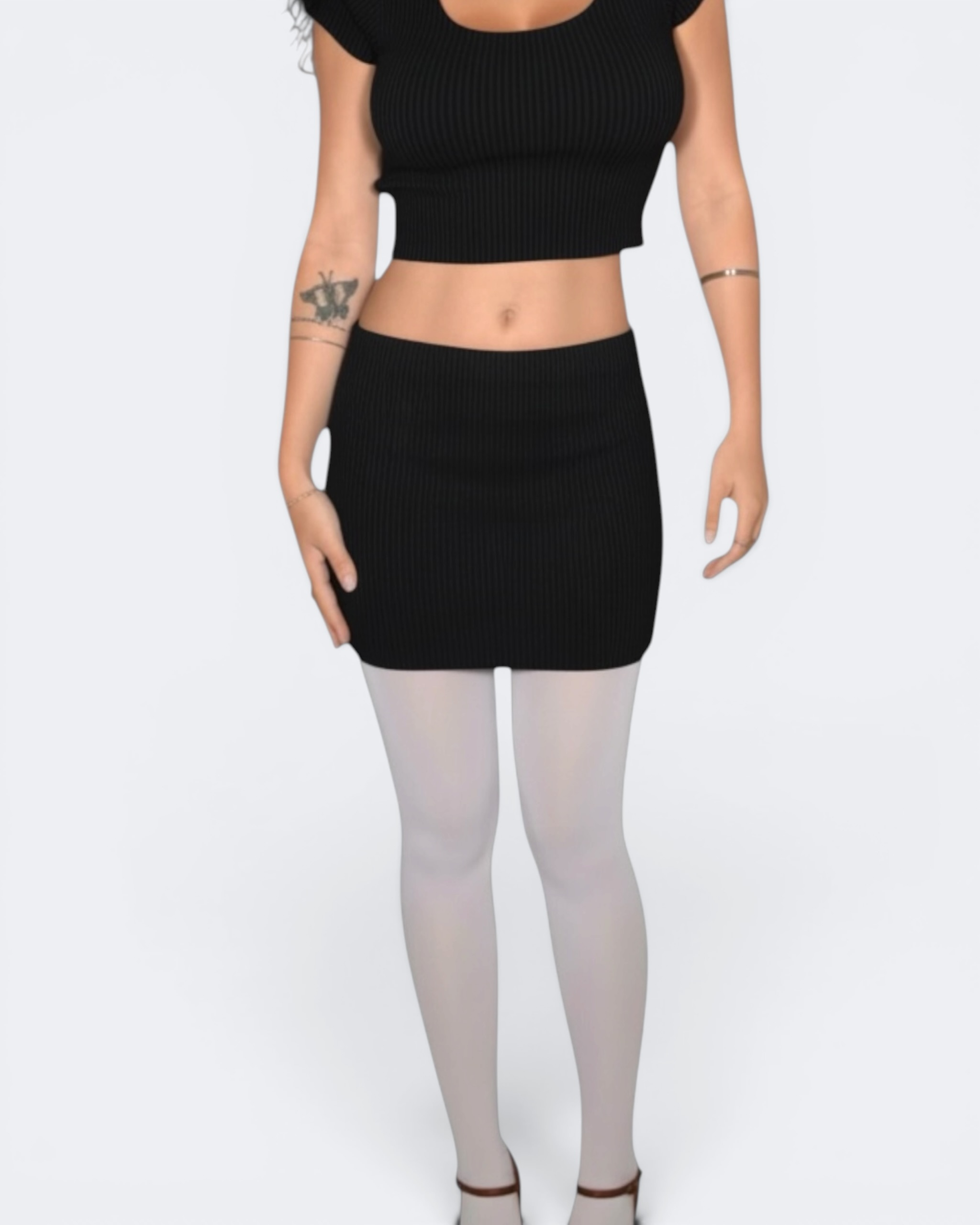 Person wearing a black crop top and black mini skirt on a white background