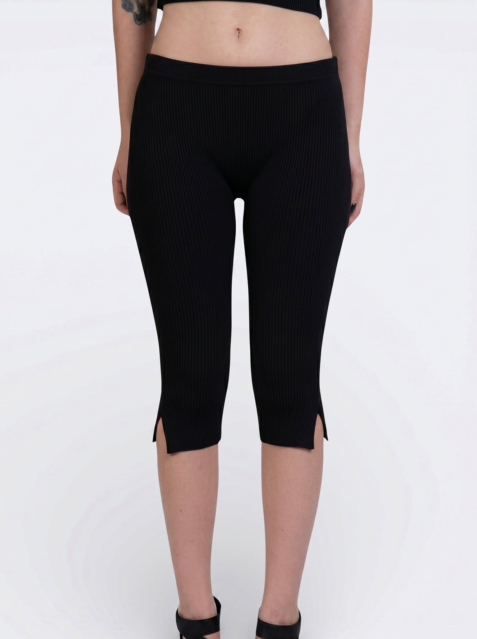 Front view of black rib knit Capri with side slit by TKHLA 