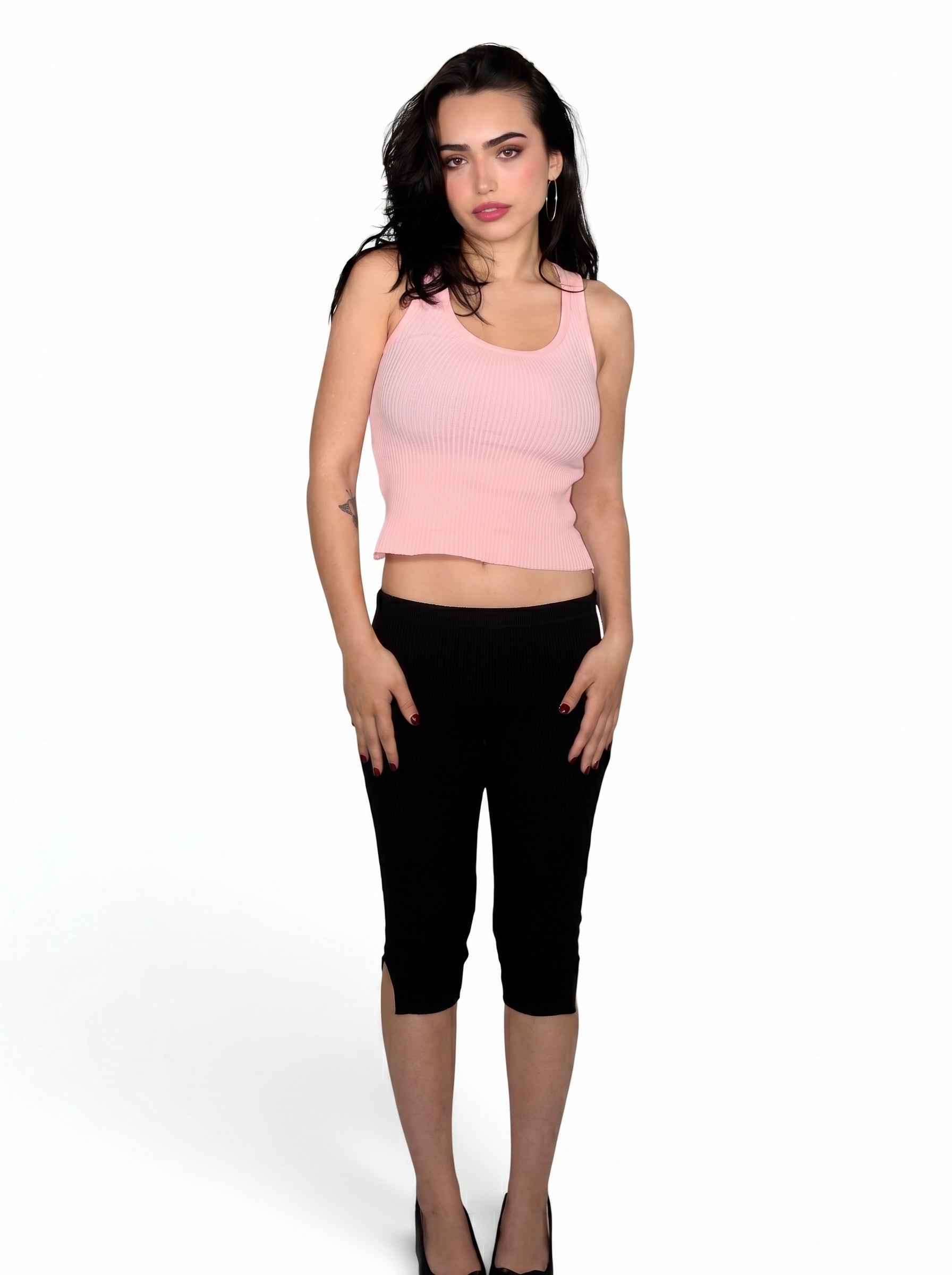 Woman wearing pink rib knit scoop neck tank and black capris with slit by TKHLA