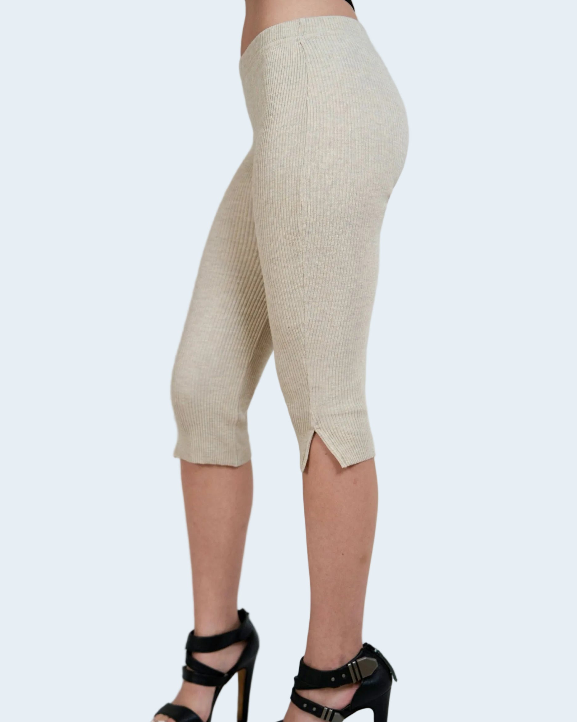 Beige capri pants worn by a person on a plain background