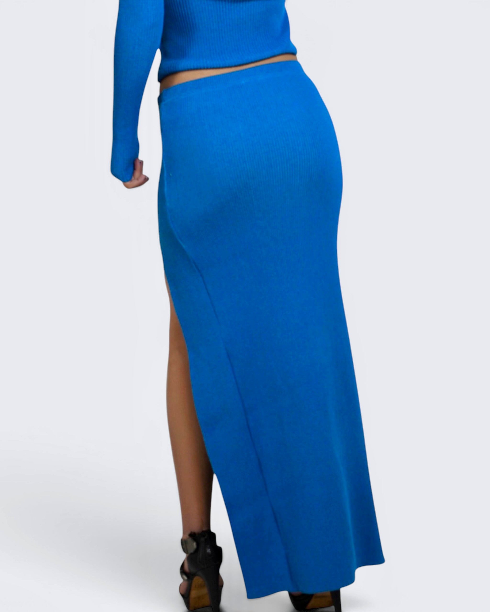 Blue long-sleeve top and high-waisted skirt on a white background