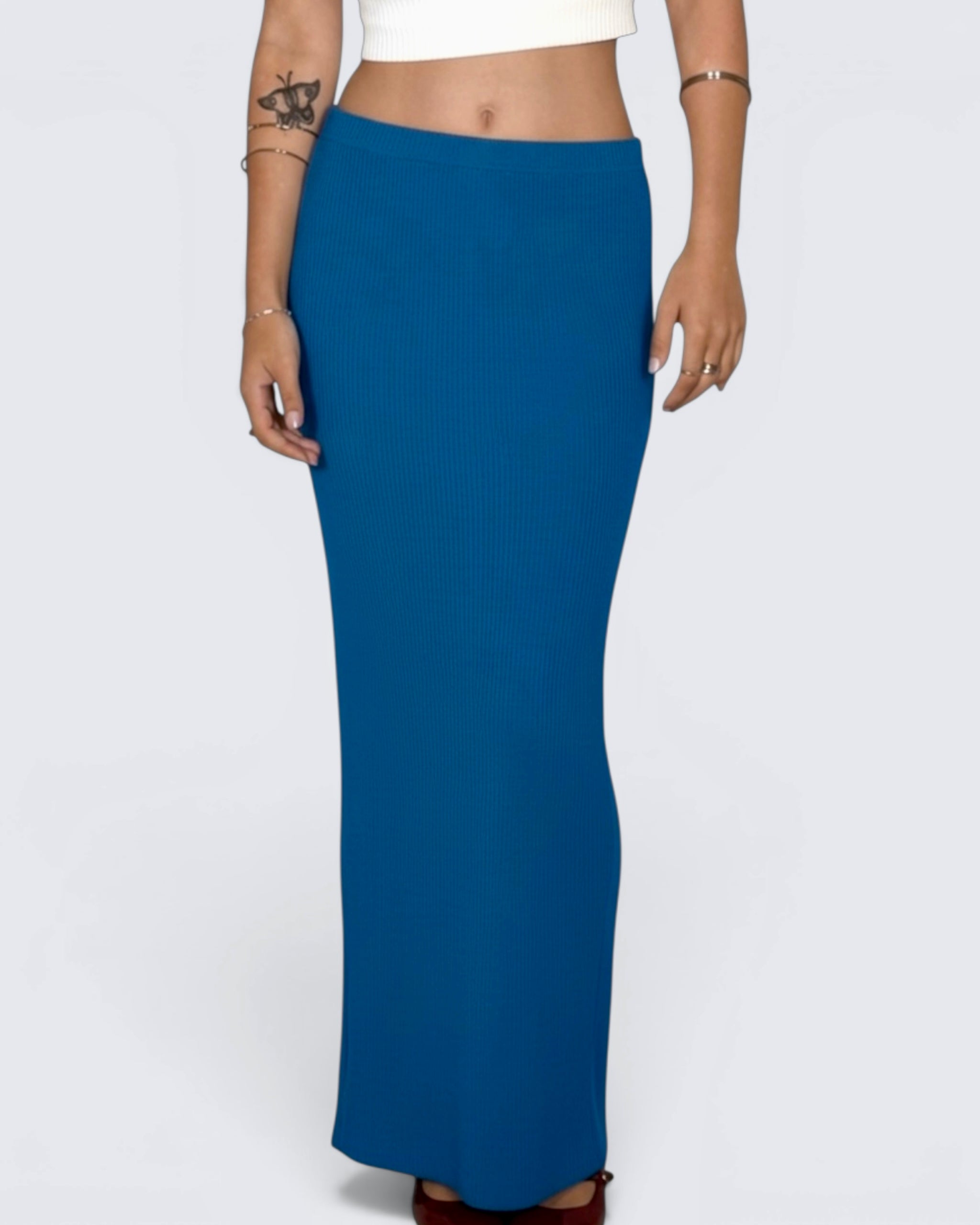 Blue skirt worn by a person on a white background