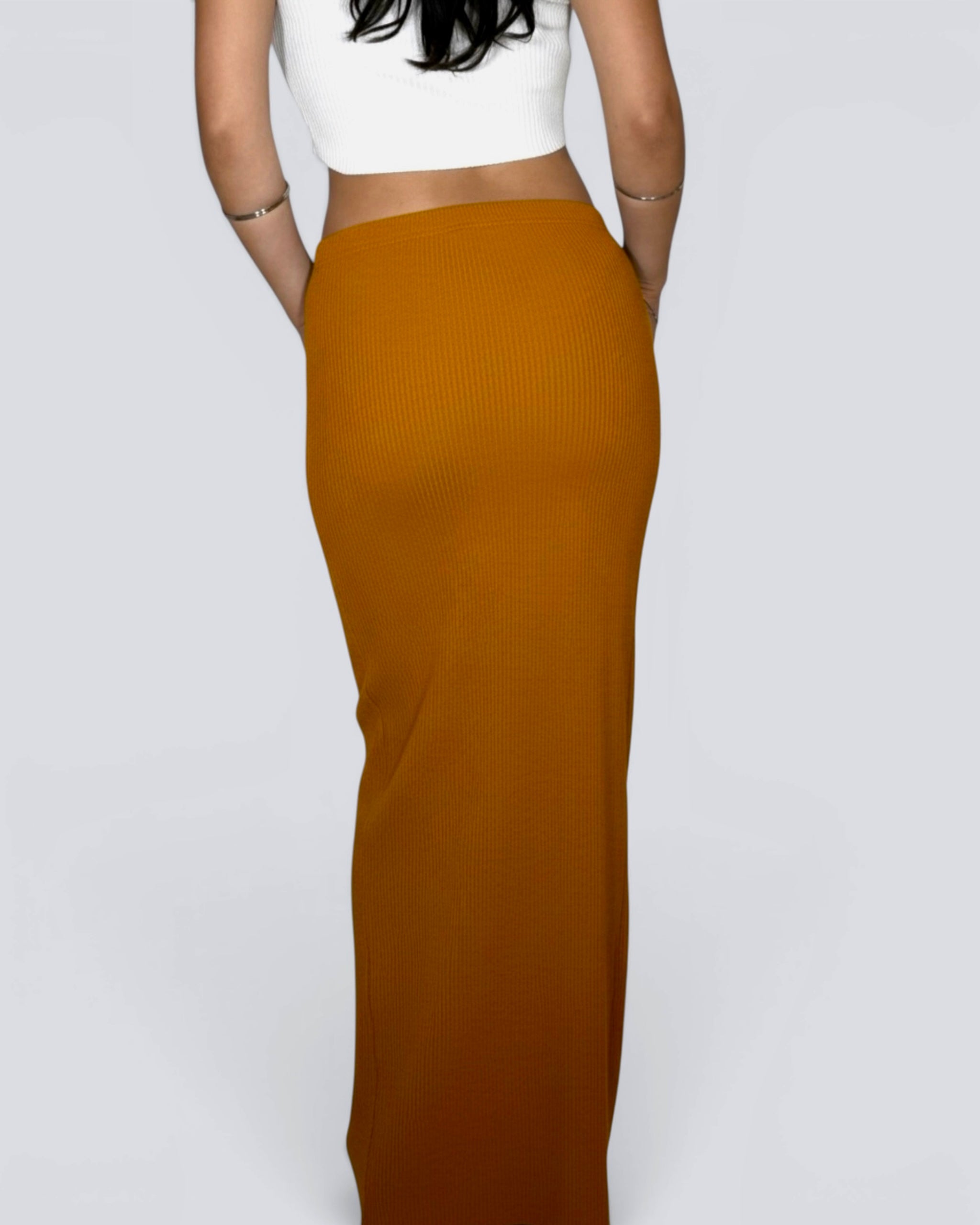 Woman wearing long straight mustard rib knit skirt by The Knit House LA