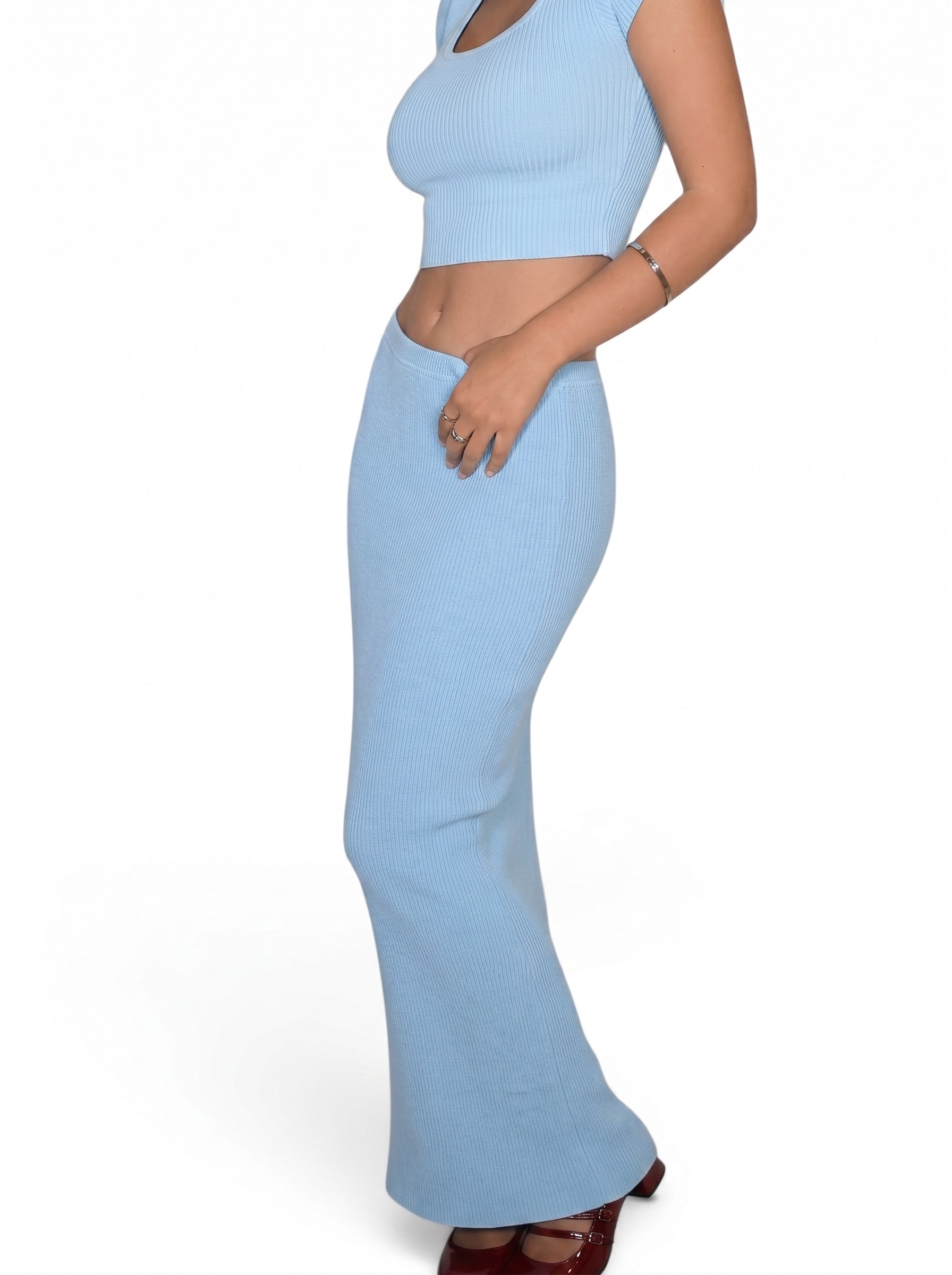 Light blue outfit with a crop top and flared pants on a white background