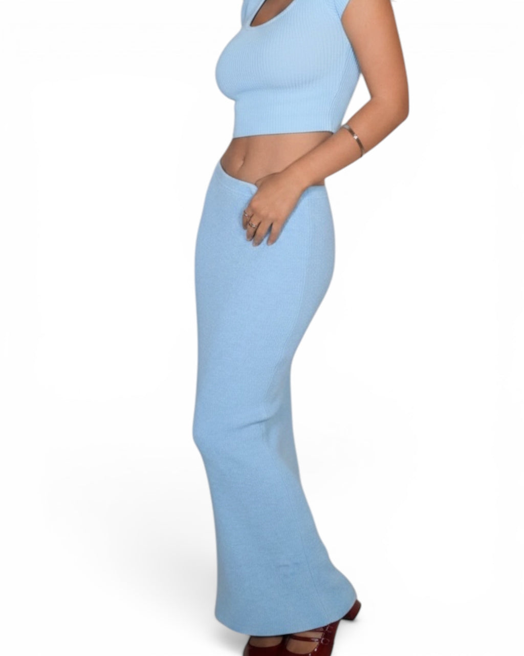 Light blue outfit with a crop top and flared pants on a white background