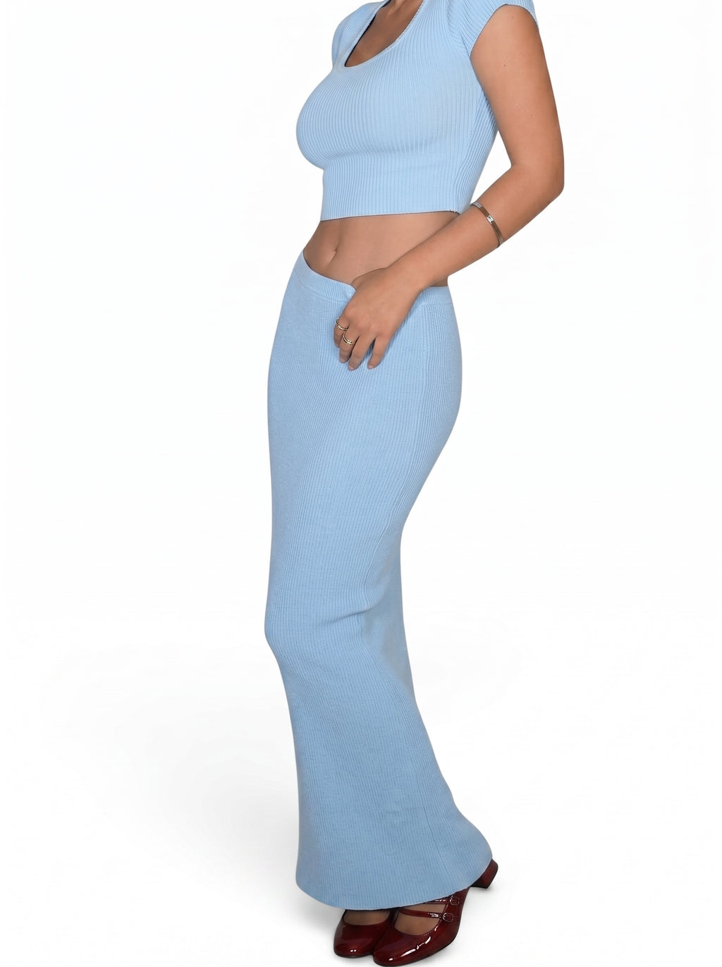 Person wearing soft blue rib knit crop scoop neck and tube skirt by TKHLA 