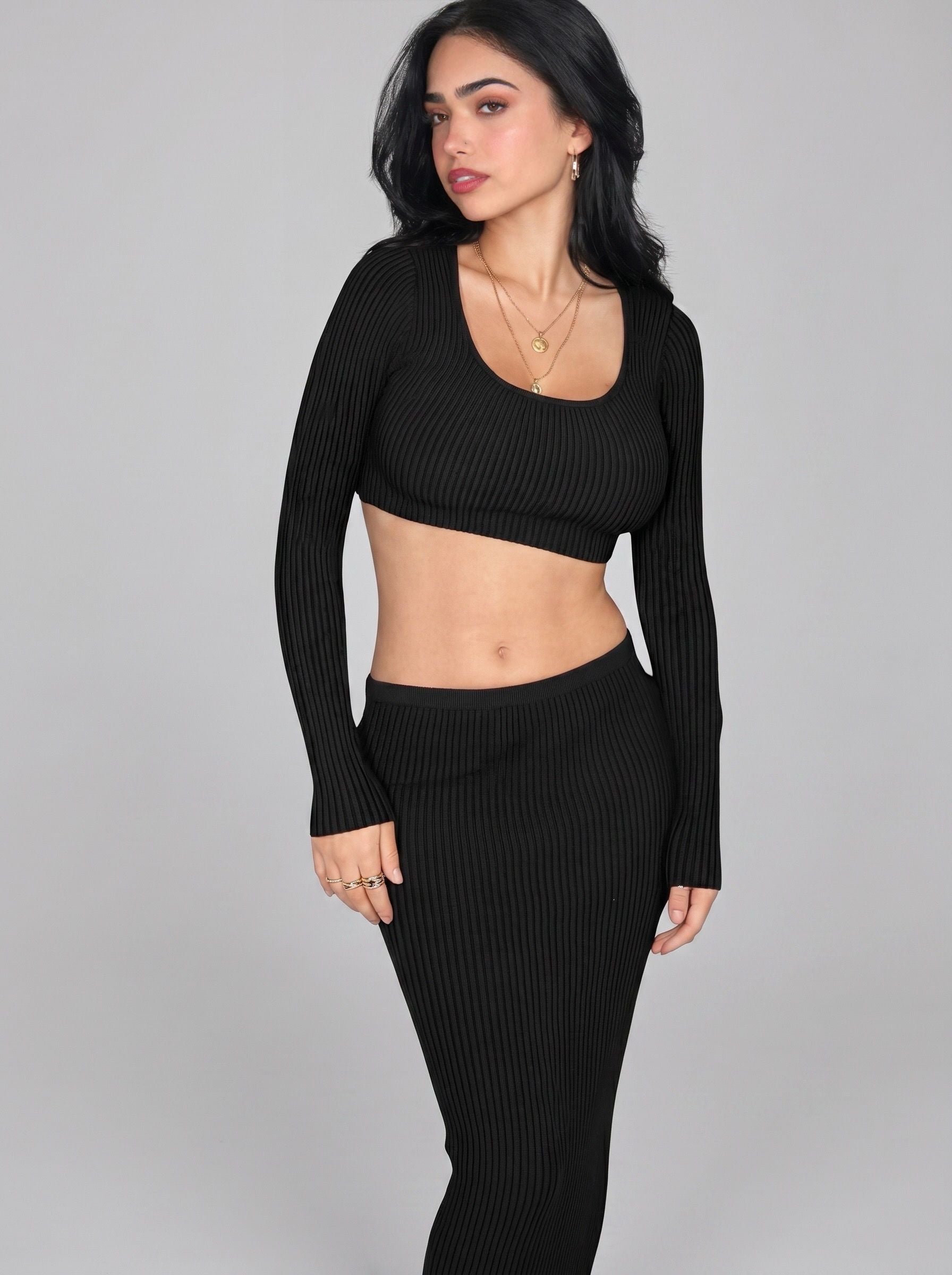 Woman wearing matching black rib knit crop long sleeve top and long straight skirt by TKHLA 