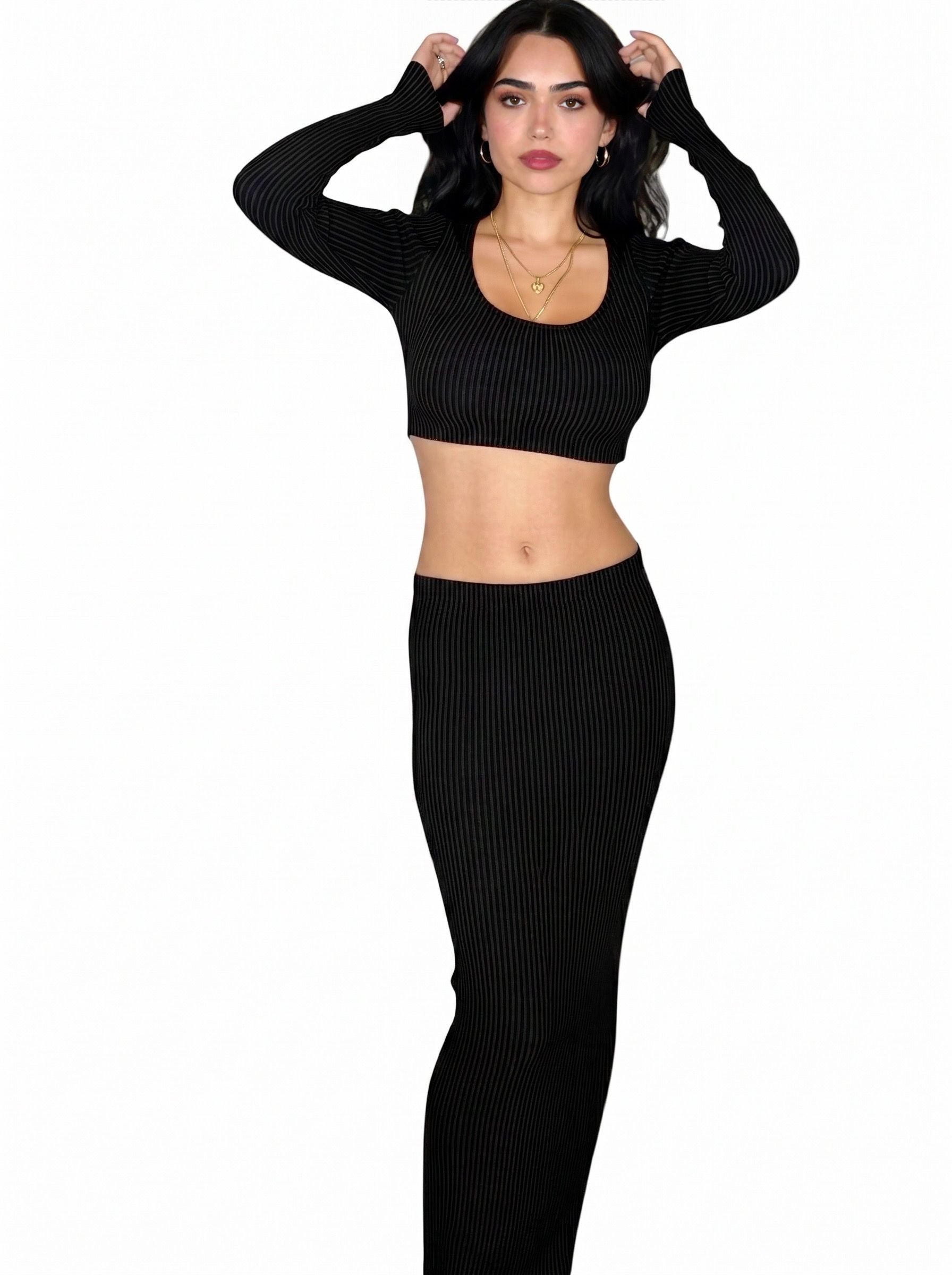 Woman wearing matching black rib knit long sleeve crop top and long straight skirt by TKHLA 