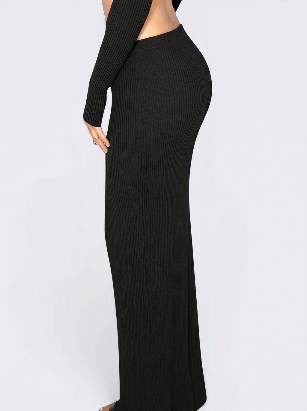 Close up of person wearing black rib knit long straight skirt by TKHLA 