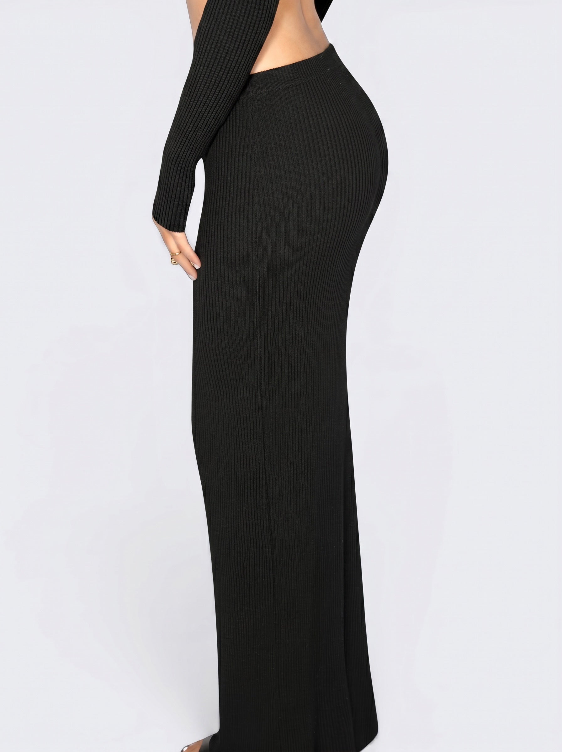 Close up of person wearing black rib knit long straight skirt by TKHLA 