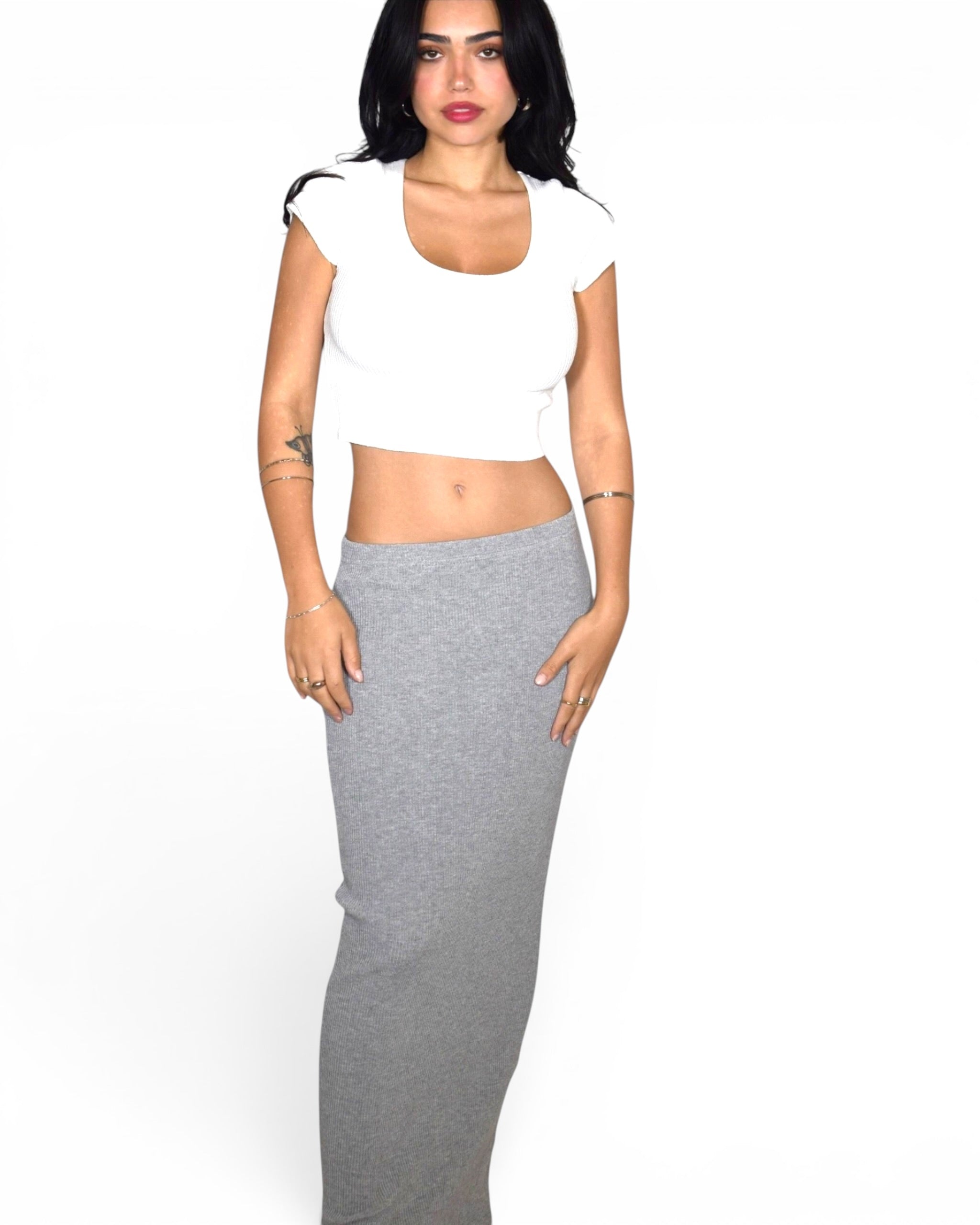 Woman wearing white short sleeve scoop neck with grey long straight skirt by TKHLA