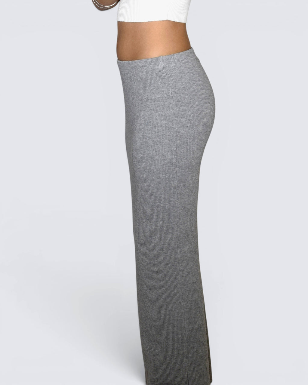 Gray long straight skirt worn by a person on a white background