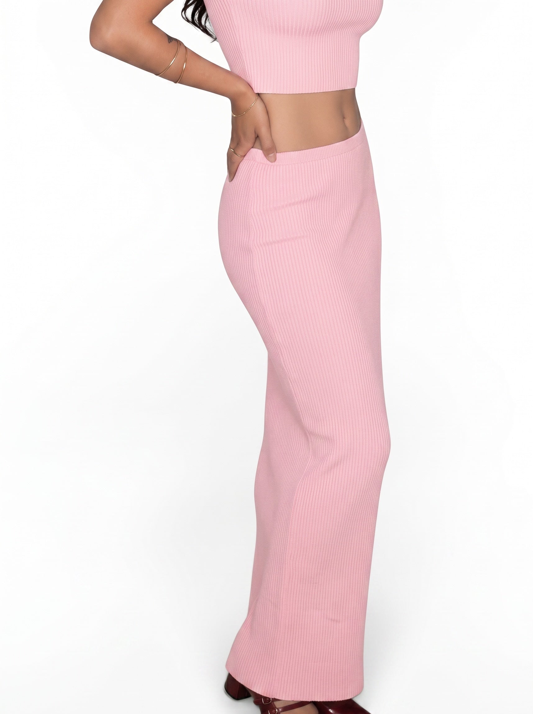Woman wearing matching pink rib knit crop scoop neck top and long skirt by TKHLA 