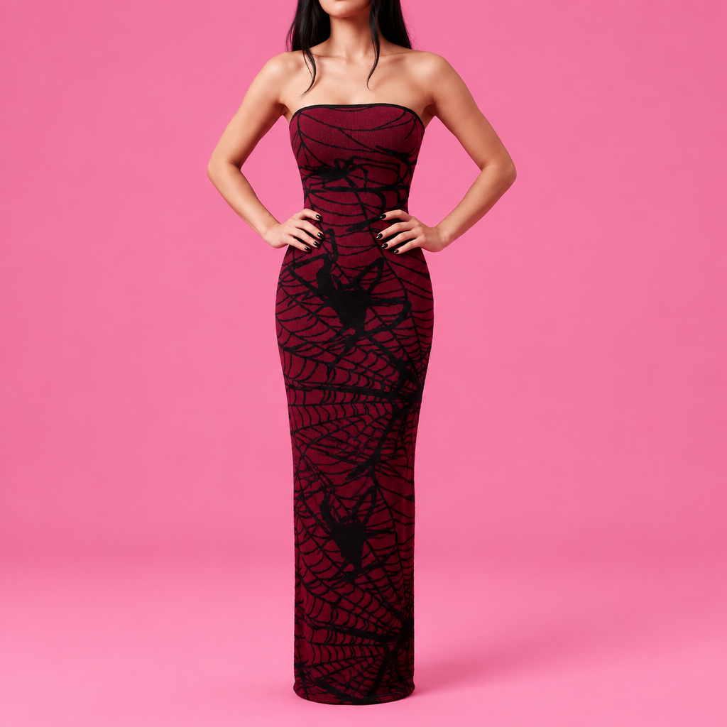 woman wearing a burgandy spider dress in a pink background