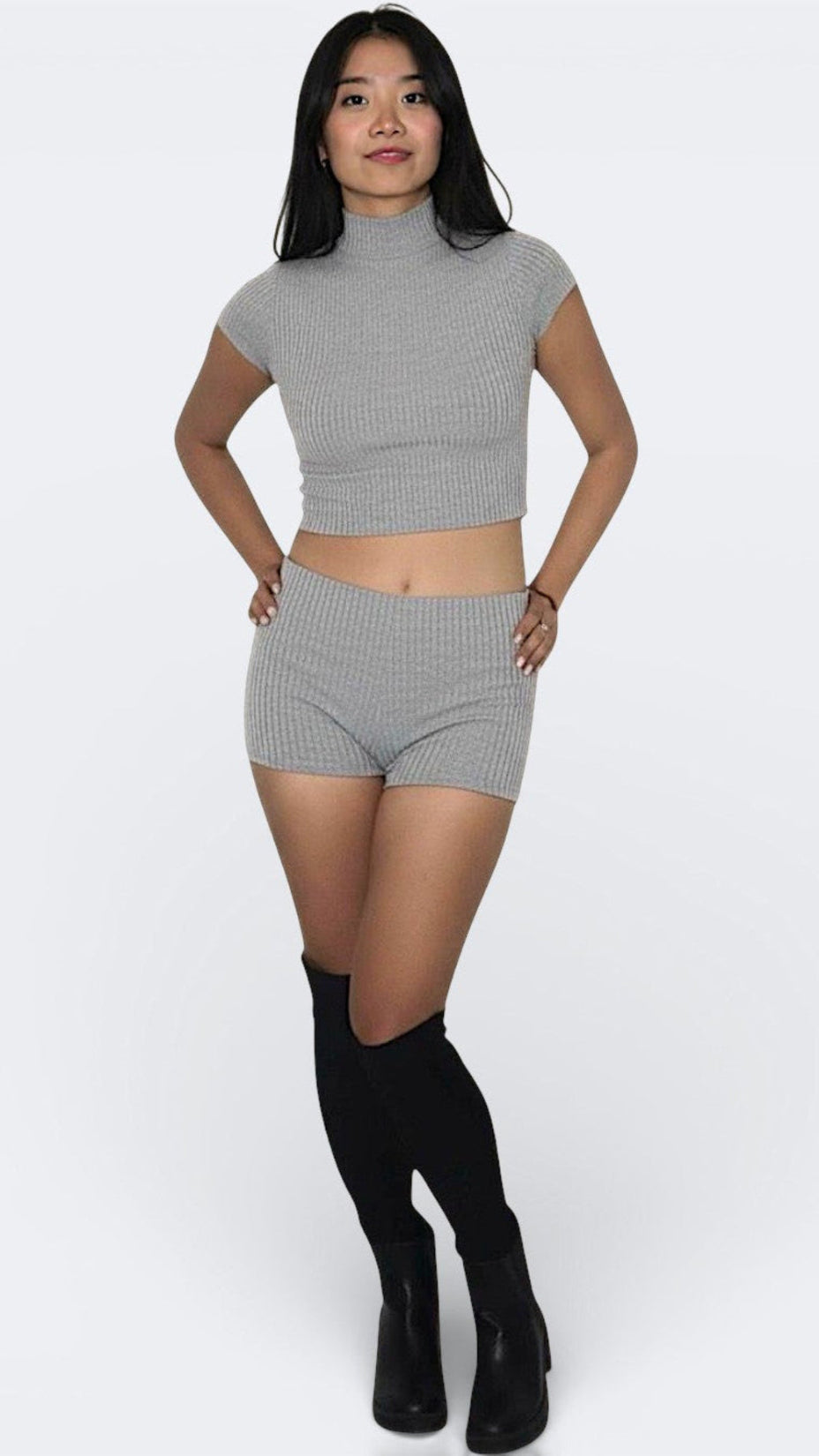 Woman wearing a pair of fitted rib knit hot pant shorts in Mist grey by The Knit House LA.