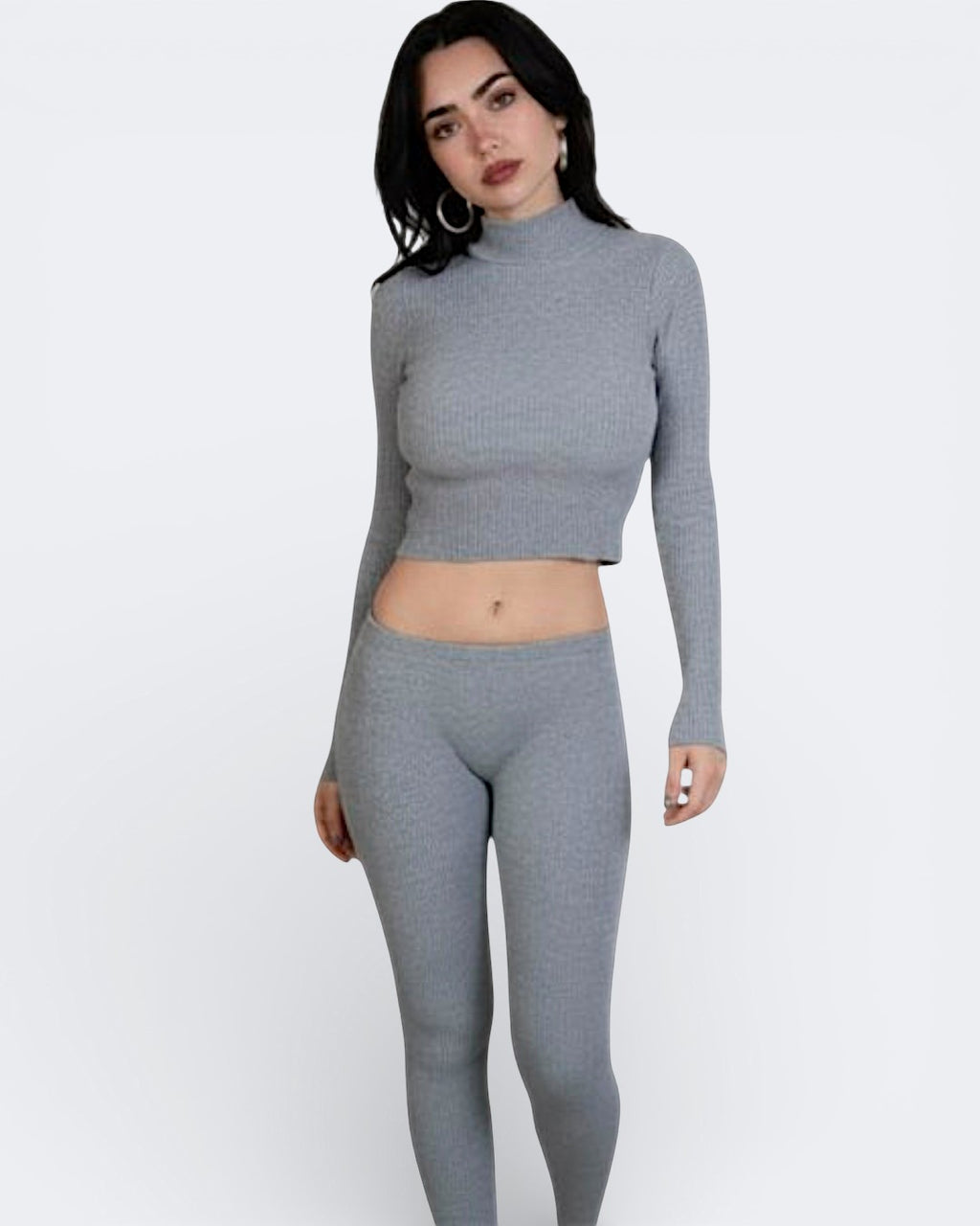 Woman wearing a fitted rib knit long sleeve crop top with high neck in Mist grey by The Knit House LA.