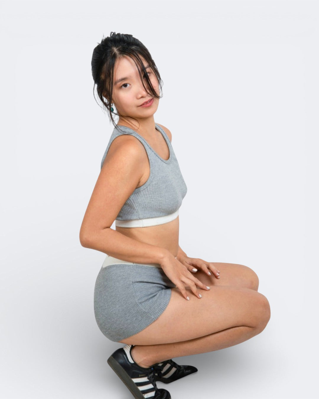 woman wearing fitted rib knit crop tank with scoop neckline and white band with matching long skirt in Mist grey by The Knit House LA.