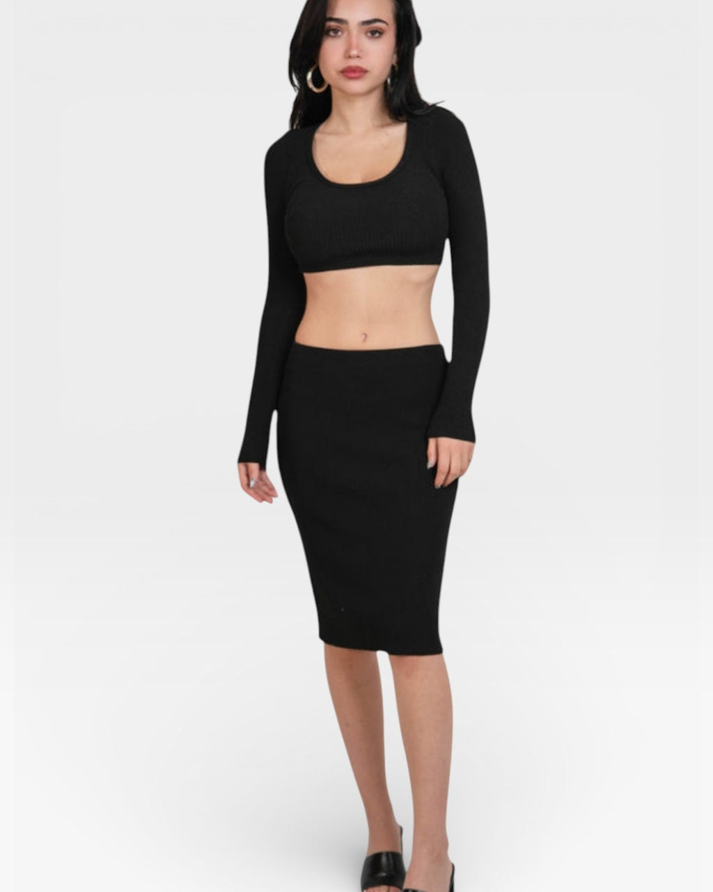 Woman wearing a fitted rib Ink black long-sleeve crop top and pencil skirt by the Knit House LA.