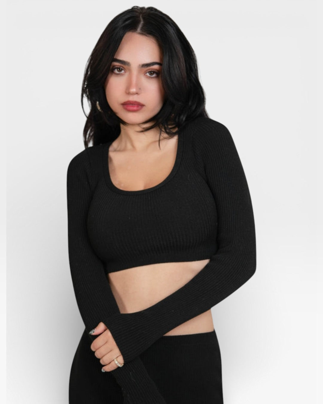 Woman wearing a fitted rib Ink black long-sleeve crop top and pencil skirt by the Knit House LA.