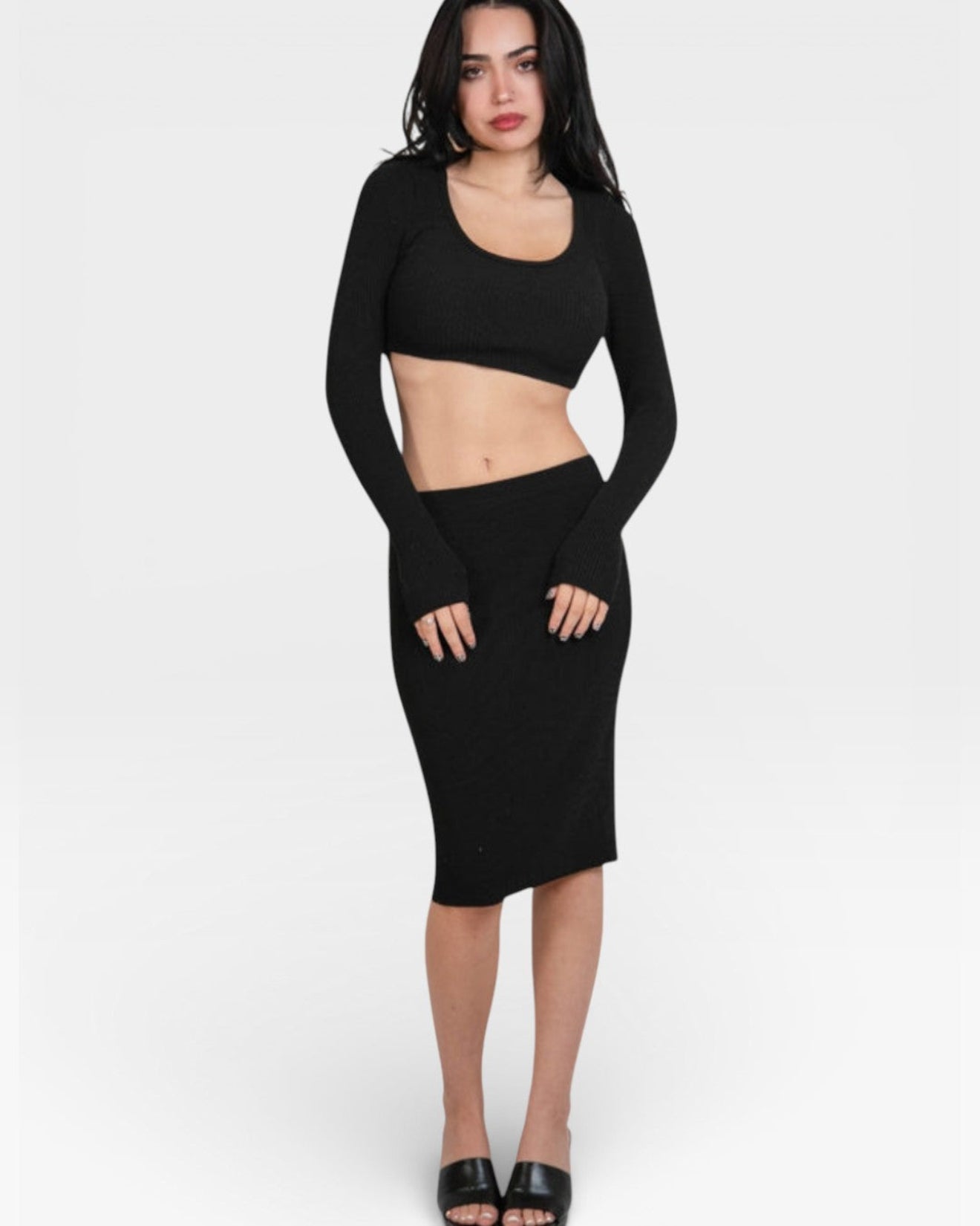 Woman wearing a fitted rib Ink black long-sleeve crop top and pencil skirt by the Knit House LA.
