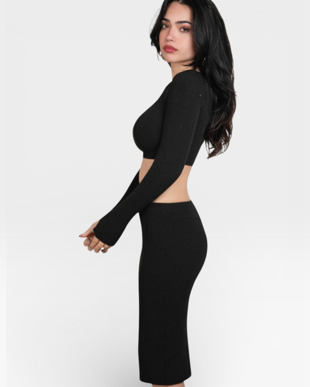 Woman wearing a fitted rib Ink black long-sleeve crop top and pencil skirt by the Knit House LA.