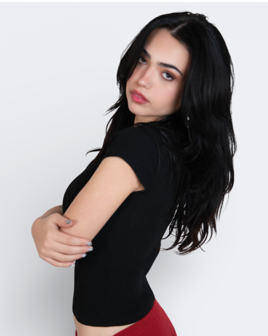 Woman wearing a scoop neck rib knit black top against a white background- The Knit House LA