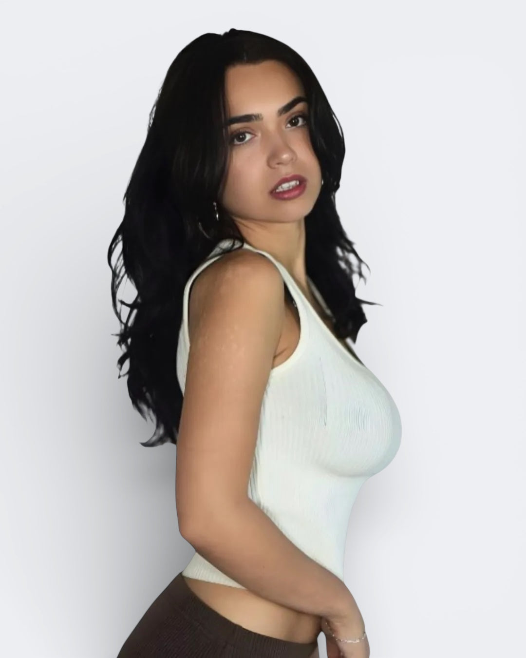 Woman wearing a Porcelain white rib knit tank top with scoop neckline by The Knit House LA  against a plain background