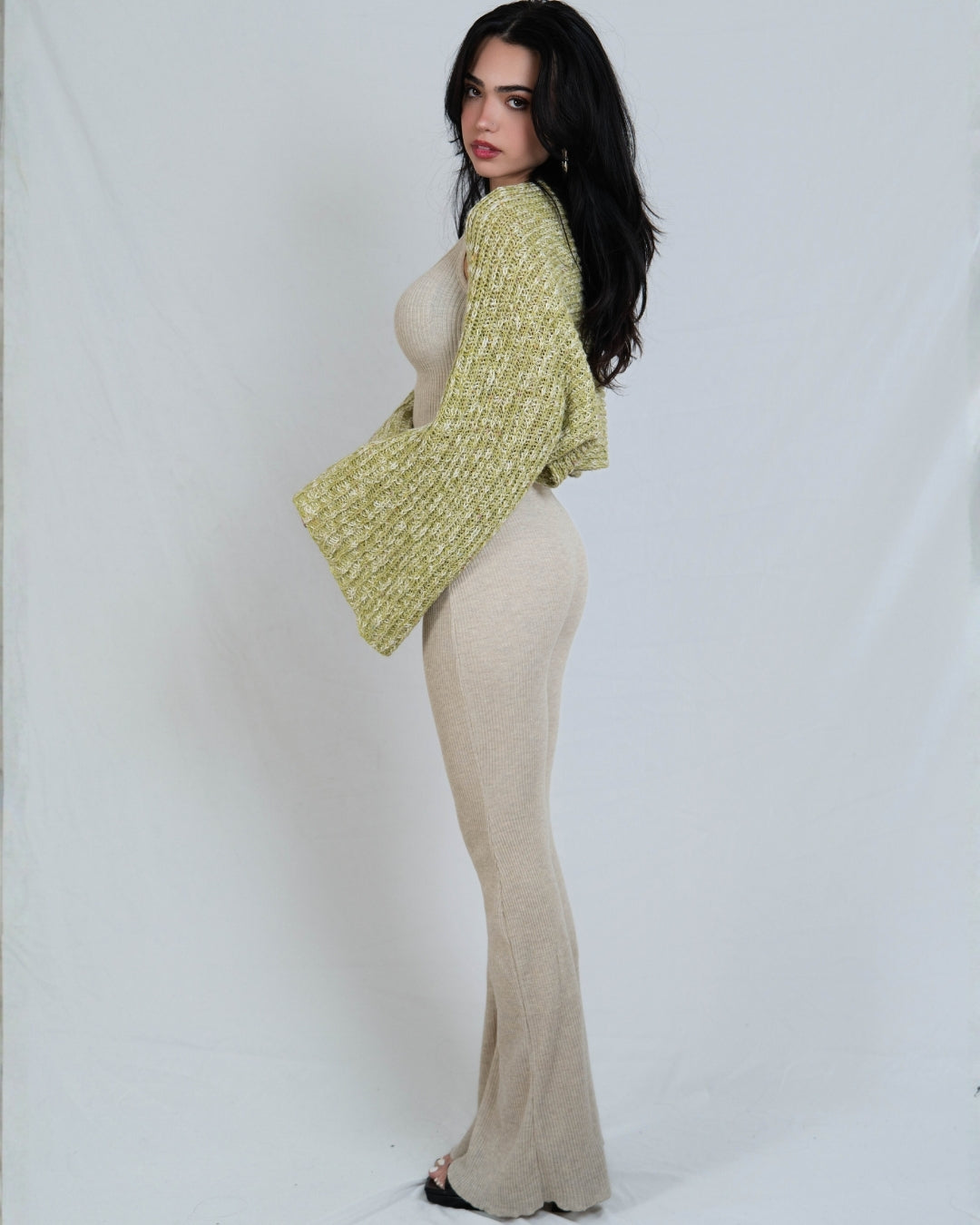 woman wearing a long sleeve dill green knit shrug over drift beige outfit by The Knit House La.